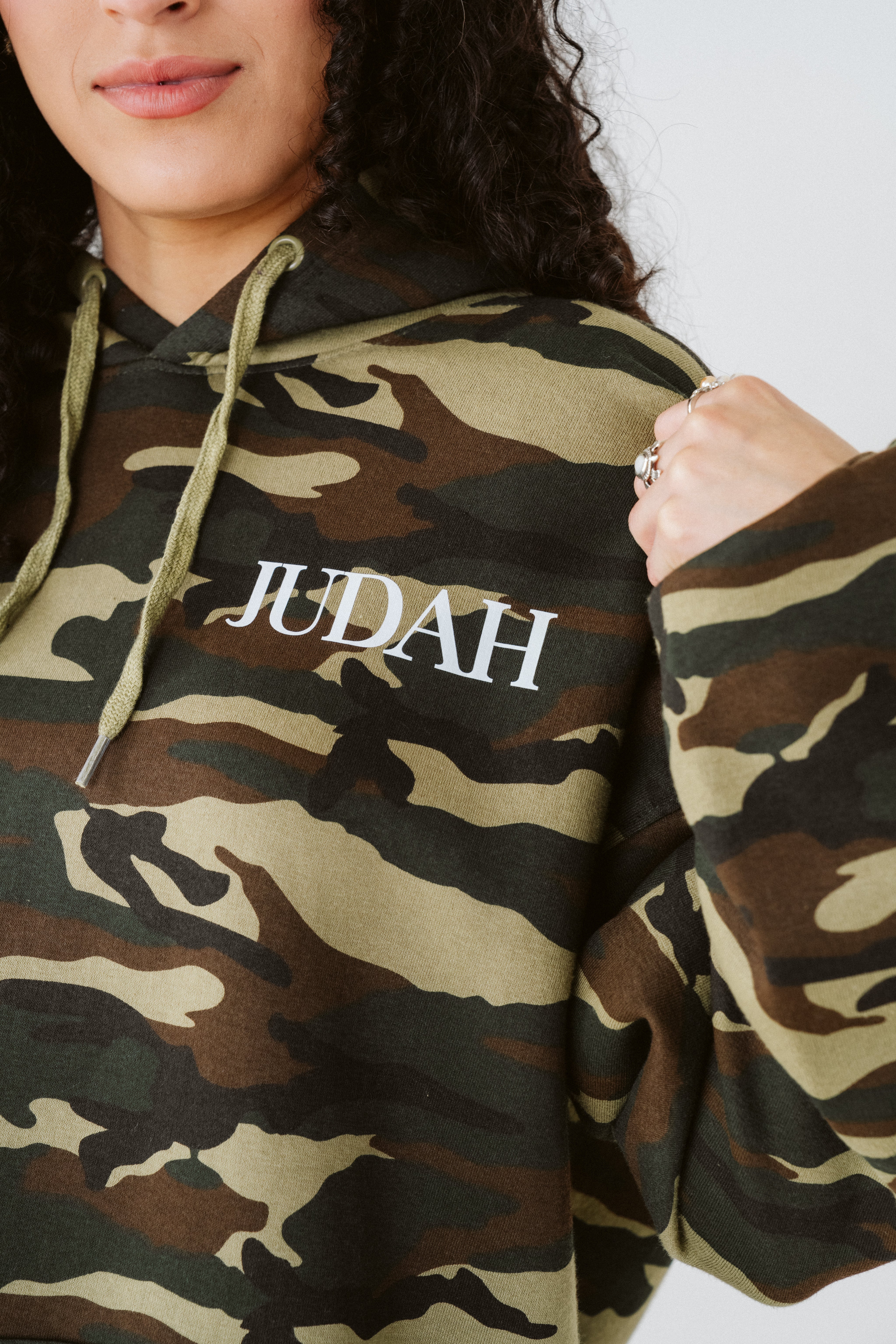 Camouflage hoodie with 'JUDAH' text on a plain background