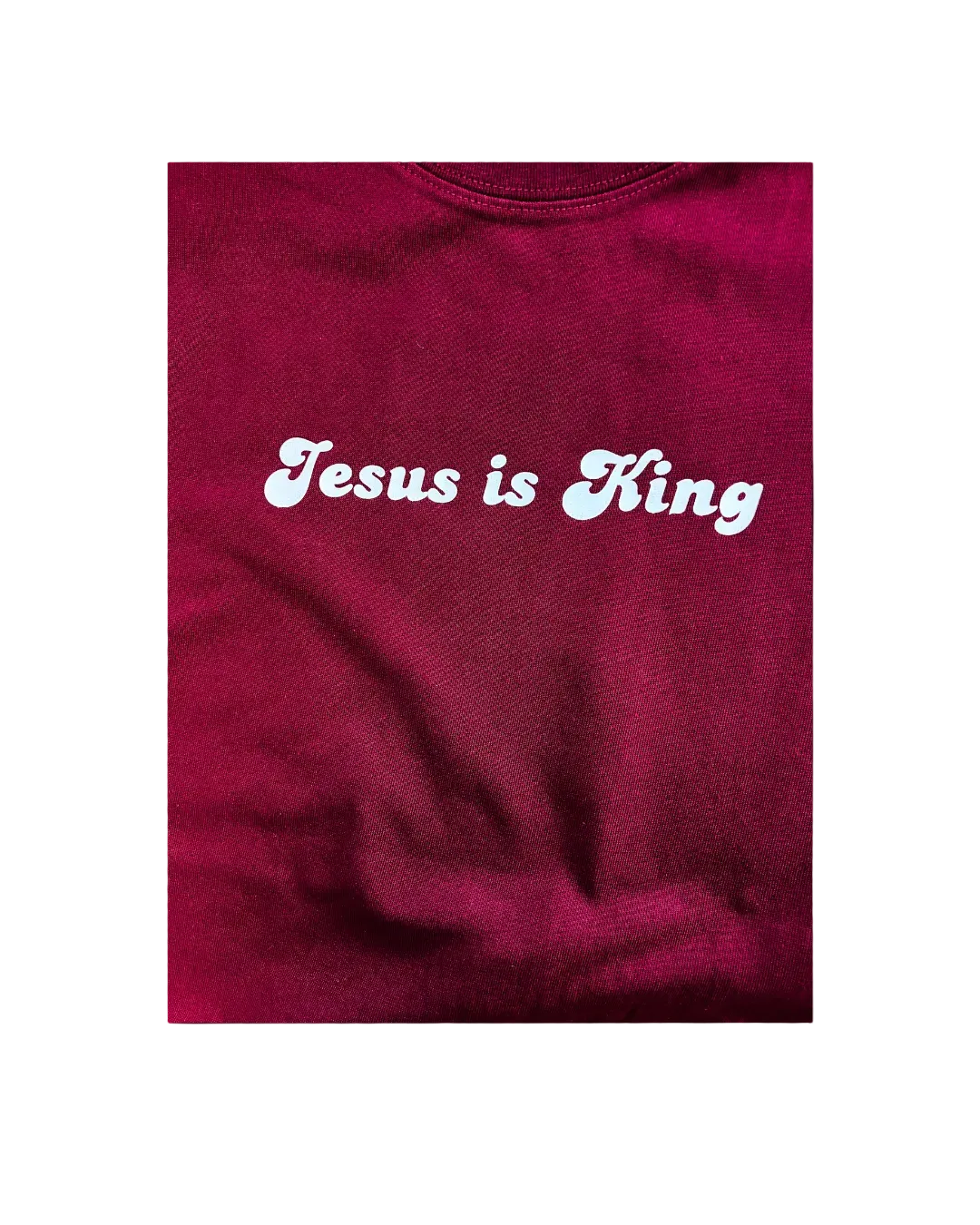 Red sweatshirt with 'Jesus is King' text in white on a white background