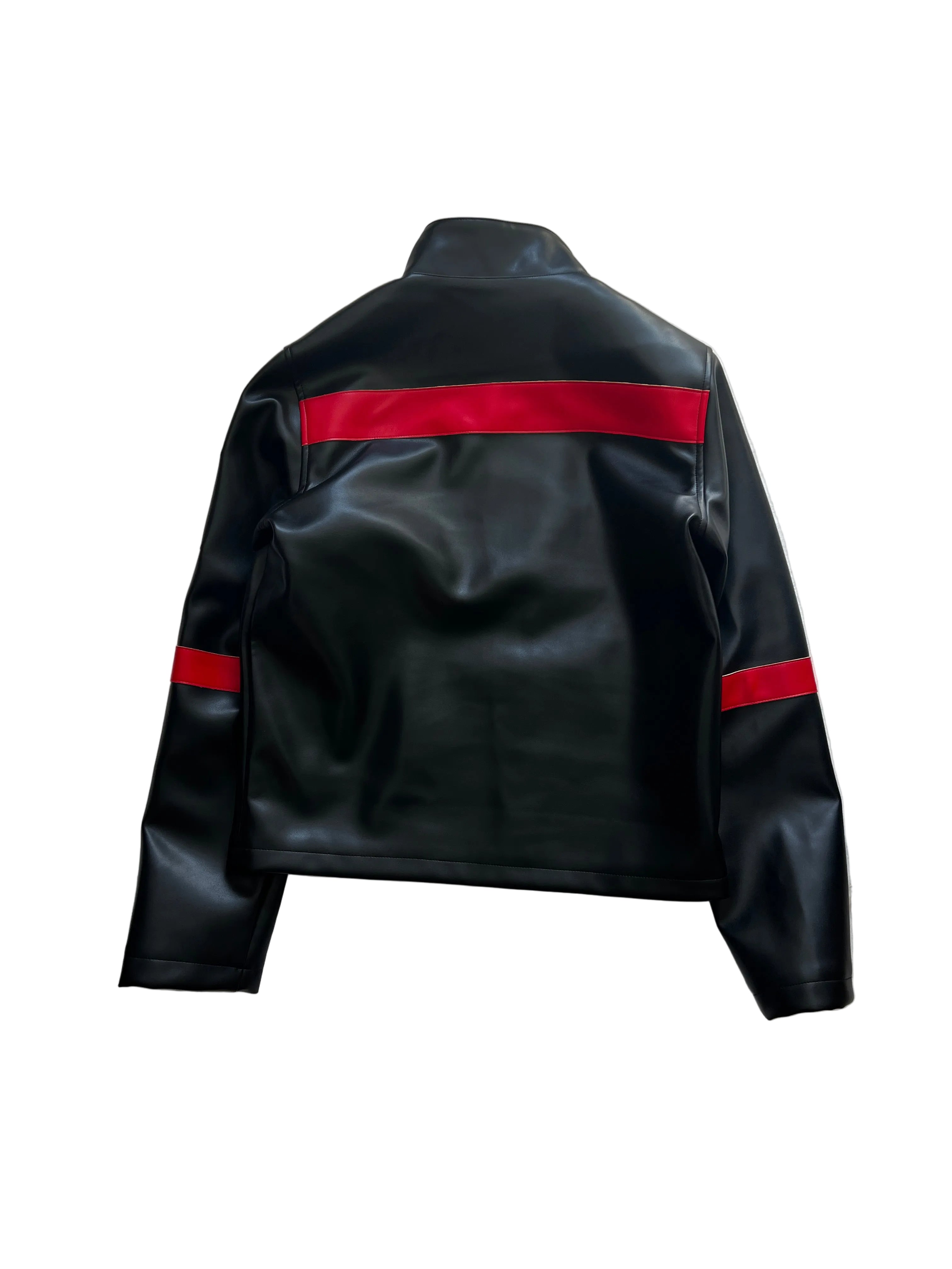 Black leather jacket with red accents on a white bedspread